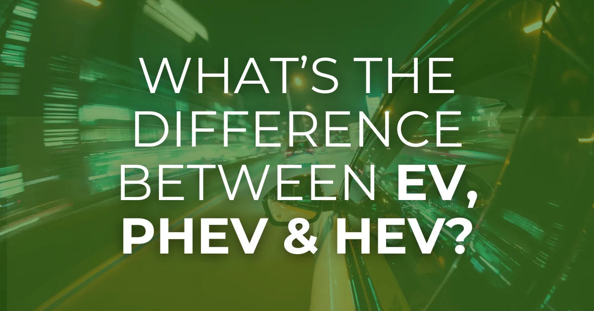 A car driving through a city at night with the text 'What’s the Difference Between EV, PHEV & HEV?